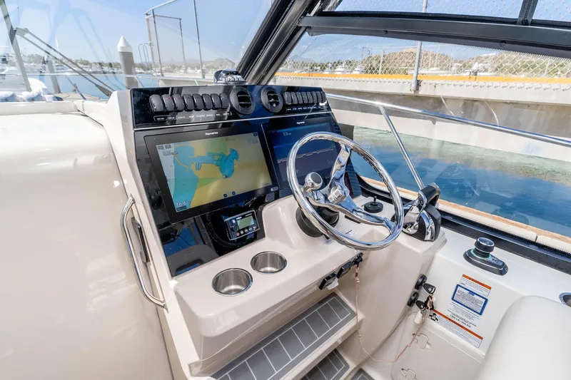 A Day In The Life Yacht Photos Pics 2021 Boston Whaler 325 Conquest helm with navigation display and steering wheel.