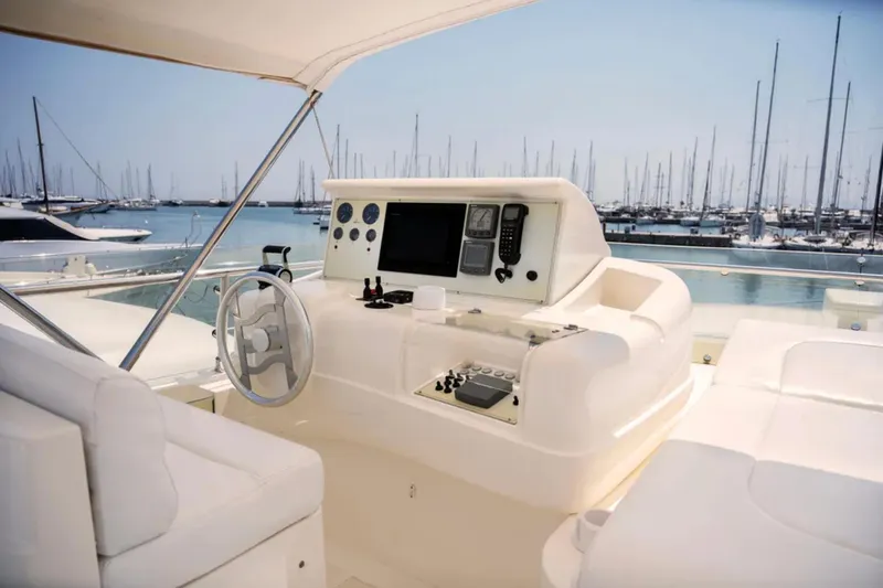  Yacht Photos Pics Cockpit of 2003 Ferretti Yachts 760 with marina view, featuring modern navigation equipment.