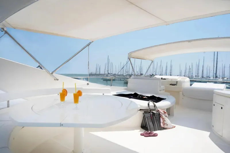  Yacht Photos Pics Luxurious 2003 Ferretti Yachts 760 deck with drinks, overlooking marina.