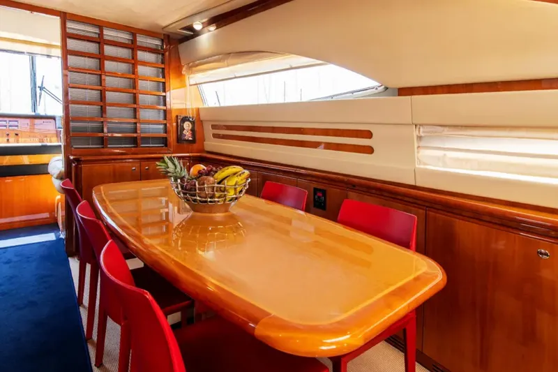  Yacht Photos Pics Luxurious dining area on 2003 Ferretti Yachts 760 with wooden table and red chairs.