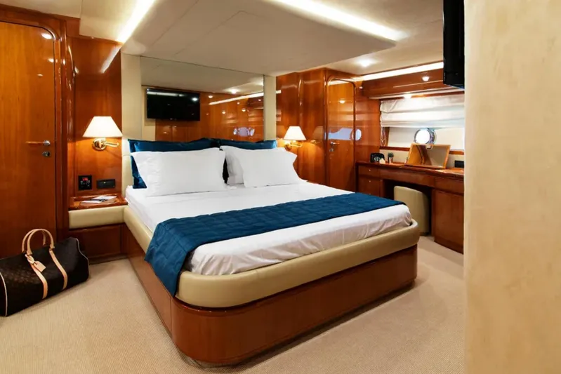  Yacht Photos Pics Luxurious bedroom interior of 2003 Ferretti Yachts 760 with elegant wood finishes.