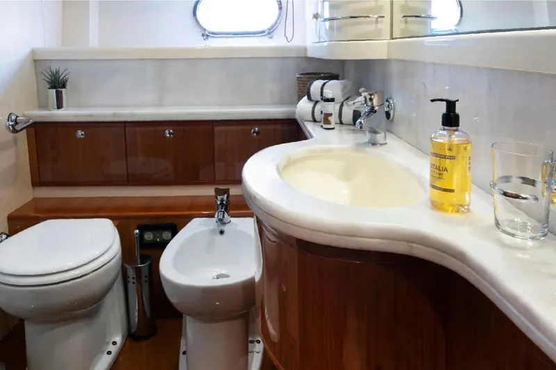  Yacht Photos Pics Luxurious bathroom in 2003 Ferretti Yachts 760, featuring elegant fixtures and wooden cabinetry.