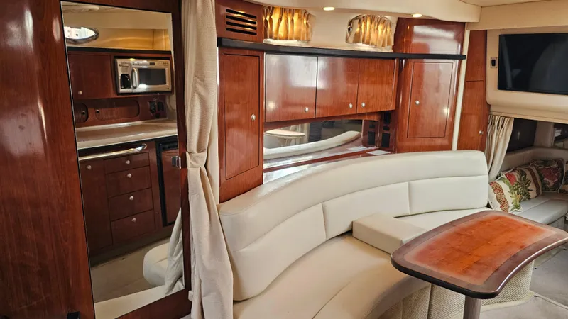 Sea Jazz Yacht Photos Pics Luxurious interior of 2007 Sea Ray 340 Sundancer with wood cabinetry and plush seating.