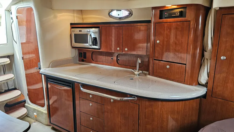 Sea Jazz Yacht Photos Pics Luxurious 2007 Sea Ray 340 Sundancer yacht interior with kitchenette and wooden cabinetry.