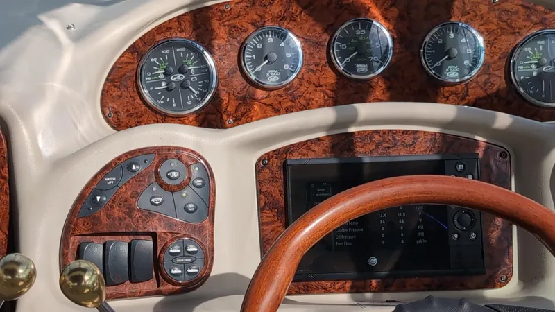 Sea Jazz Yacht Photos Pics Dashboard of a 2007 Sea Ray 340 Sundancer boat with wood accents and gauges.