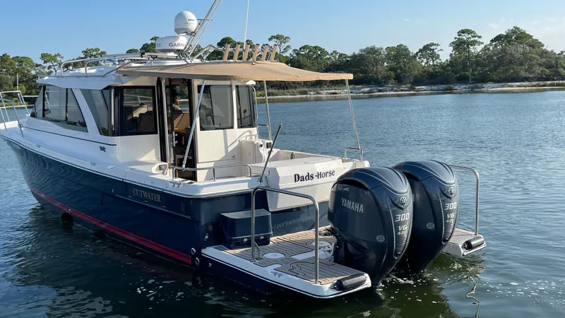  Yacht Photos Pics 2022 Cutwater C-32 Sedan boat with twin Yamaha engines on a calm lake.