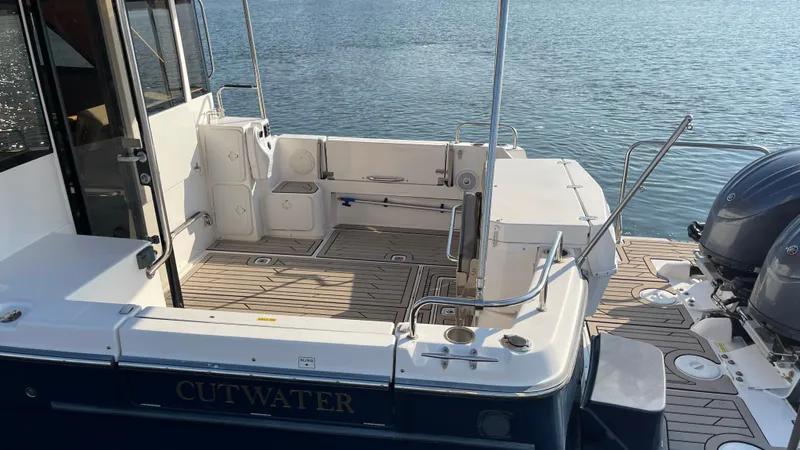  Yacht Photos Pics 2022 Cutwater C-32 Sedan boat, featuring spacious deck and dual outboard motors.