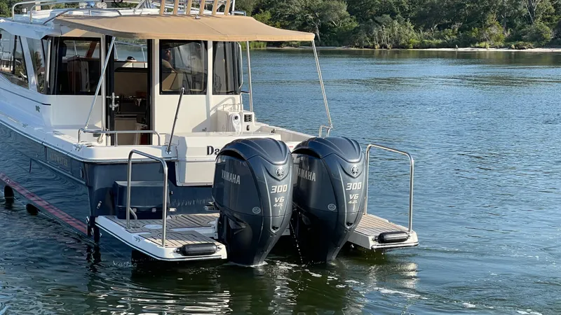  Yacht Photos Pics 2022 Cutwater C-32 Sedan with twin Yamaha 300 engines on a serene waterway.