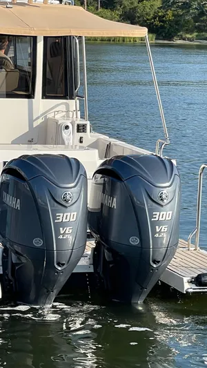  Yacht Photos Pics 2022 Cutwater C-32 Sedan with twin Yamaha 300 V6 outboard engines on a calm lake.