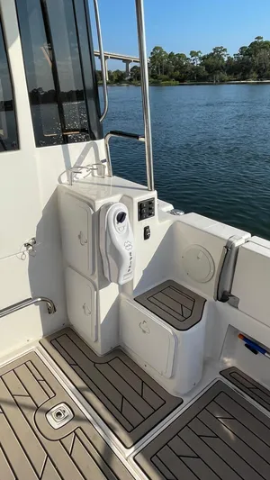  Yacht Photos Pics 2022 Cutwater C-32 Sedan boat deck with modern amenities and scenic water view.