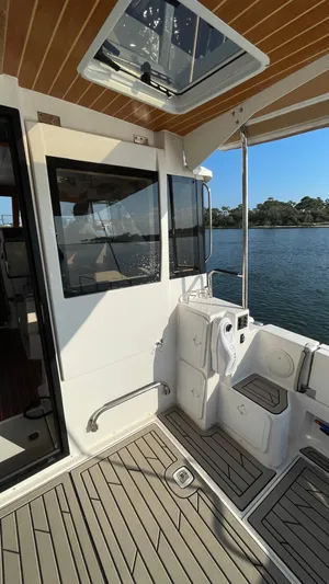  Yacht Photos Pics 2022 Cutwater C-32 Sedan boat deck with seating, overlooking serene water.
