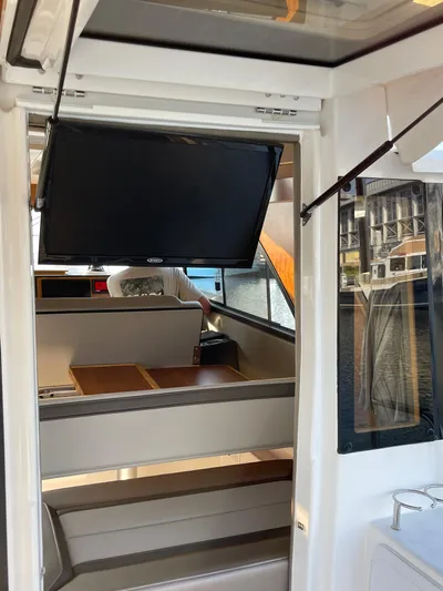  Yacht Photos Pics Interior view of 2022 Cutwater C-32 Sedan with TV and seating area.