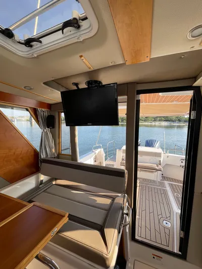  Yacht Photos Pics Interior view of 2022 Cutwater C-32 Sedan yacht with seating and TV, overlooking water.