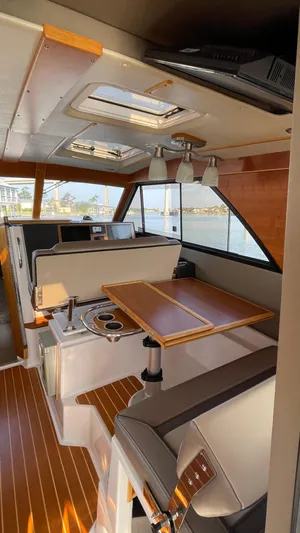  Yacht Photos Pics Interior of 2022 Cutwater C-32 Sedan boat with wood accents and seating area.