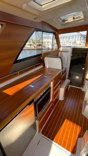  Yacht Photos Pics 2022 Cutwater C-32 Sedan interior with wood finish and modern amenities.