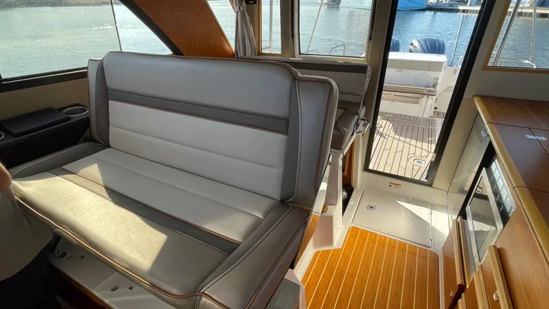  Yacht Photos Pics 2022 Cutwater C-32 Sedan interior with seating and wooden flooring.