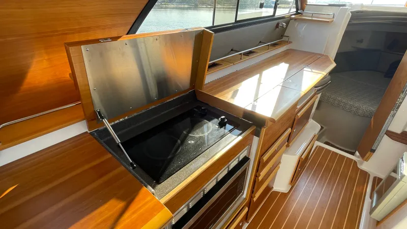  Yacht Photos Pics 2022 Cutwater C-32 Sedan interior with modern kitchen and wood finish.