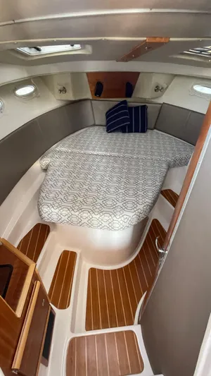  Yacht Photos Pics 2022 Cutwater C-32 Sedan cabin with cozy bed and elegant wood flooring.
