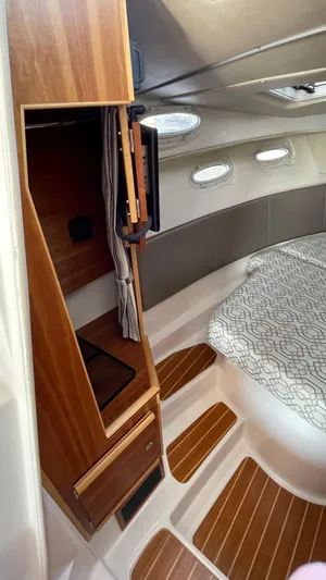  Yacht Photos Pics 2022 Cutwater C-32 Sedan interior with wood accents and patterned bedding.