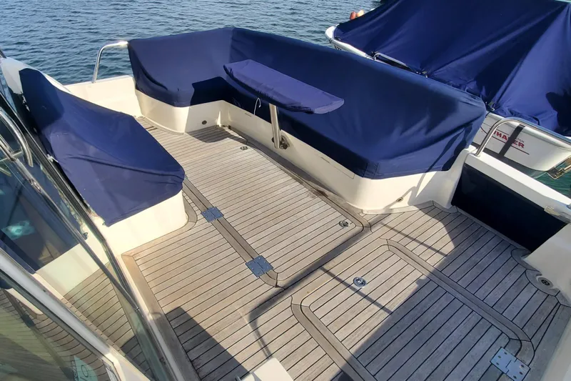 Brio Yacht Photos Pics 2012 Sabre 48 Salon Express deck with blue-covered seating and wooden flooring.
