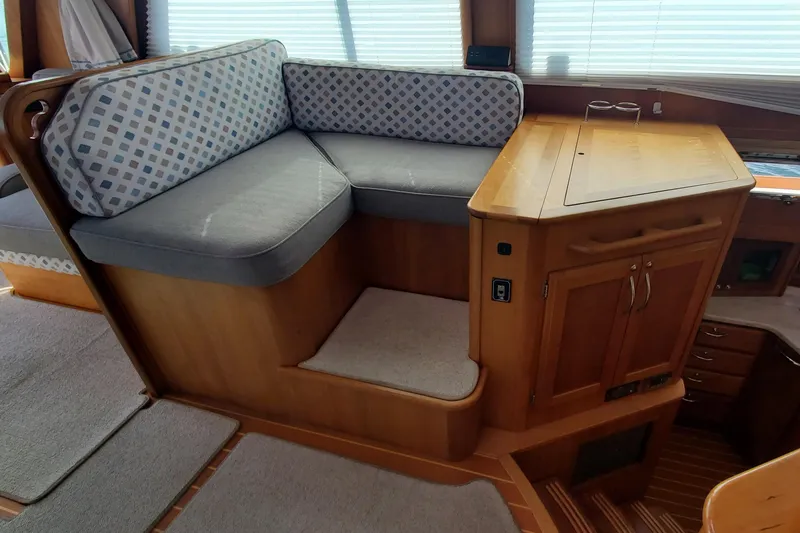 Brio Yacht Photos Pics 2012 Sabre 48 Salon Express interior with cushioned seating and wooden cabinetry.