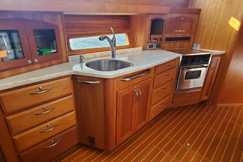 Brio Yacht Photos Pics Luxurious 2012 Sabre 48 Salon Express yacht kitchen with wood cabinetry and modern appliances.