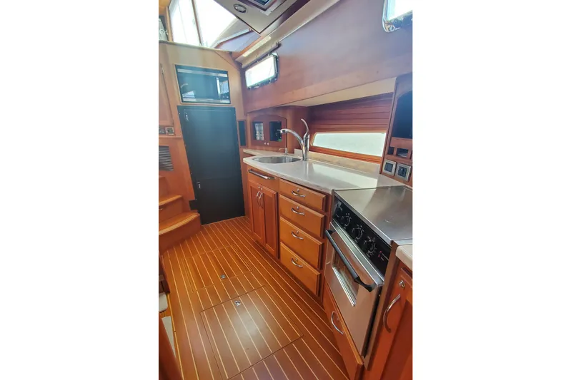 Brio Yacht Photos Pics 2012 Sabre 48 Salon Express kitchen with wood cabinetry and stainless steel appliances.