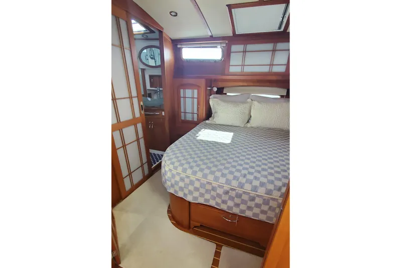 Brio Yacht Photos Pics Luxurious bedroom interior of 2012 Sabre 48 Salon Express yacht with elegant wood finish.