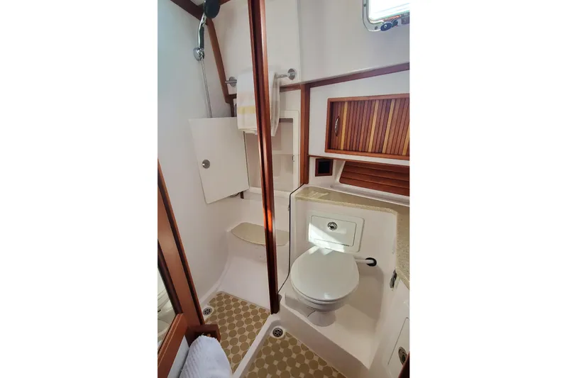 Brio Yacht Photos Pics 2012 Sabre 48 Salon Express bathroom with shower, toilet, and wooden cabinetry.