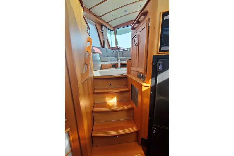 Brio Yacht Photos Pics Interior view of 2012 Sabre 48 Salon Express yacht with wooden stairs and seating area.