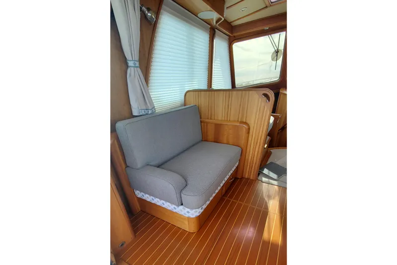 Brio Yacht Photos Pics Interior of 2012 Sabre 48 Salon Express with wooden flooring and gray seating.