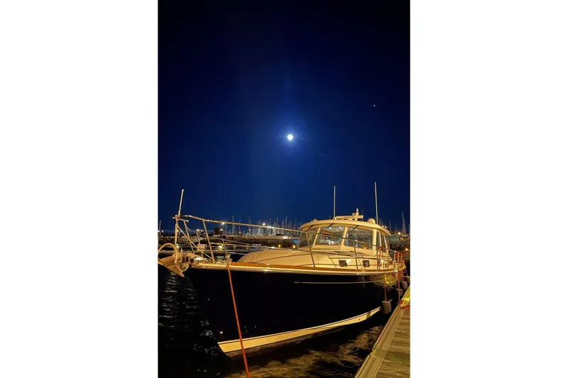 Brio Yacht Photos Pics 2012 Sabre 48 Salon Express yacht docked at night under a bright moonlit sky.