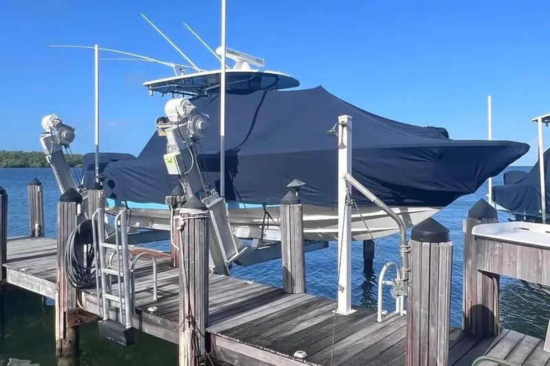  Yacht Photos Pics 2024 Contender 30 Tournament boat covered and docked on a sunny day.