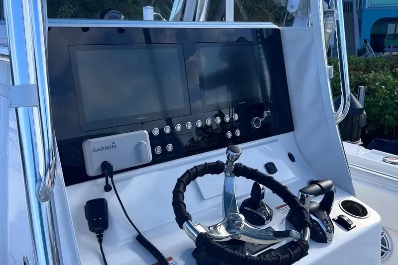 Yacht Photos Pics 2024 Contender 30 Tournament boat dashboard with Garmin navigation system and steering wheel.