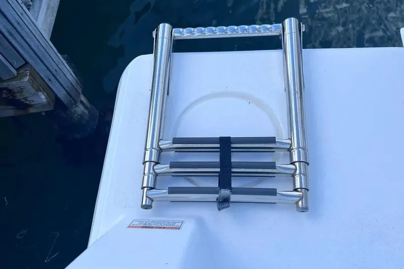  Yacht Photos Pics Folded stainless steel ladder on 2024 Contender 30 Tournament boat deck.