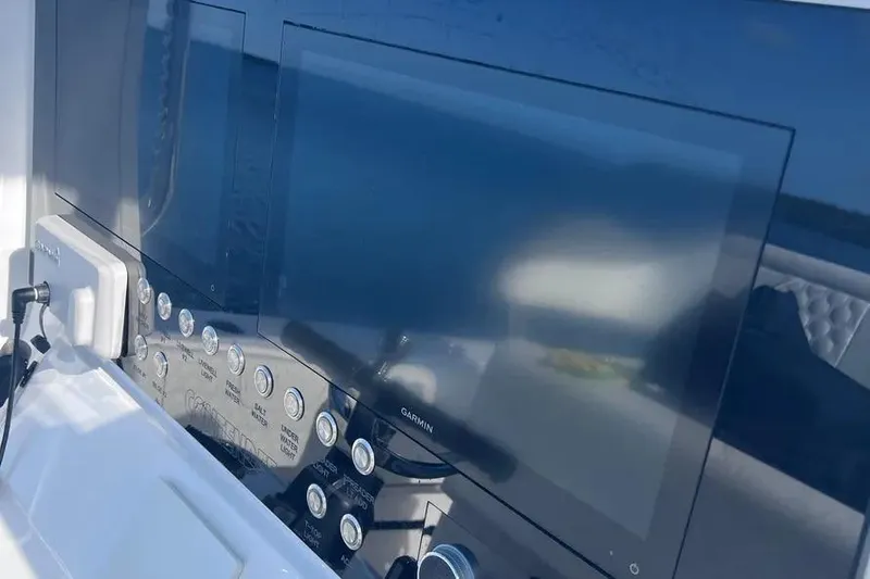  Yacht Photos Pics 2024 Contender 30 Tournament boat dashboard with Garmin navigation screens and control panel.