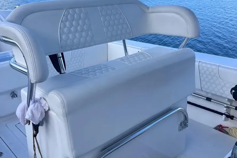  Yacht Photos Pics 2024 Contender 30 Tournament boat seating with hexagonal pattern, overlooking water.