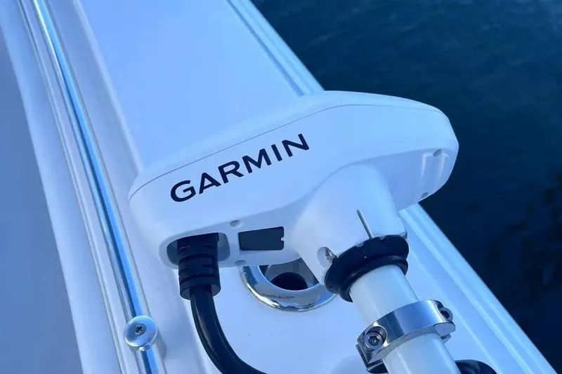  Yacht Photos Pics Garmin device on 2024 Contender 30 Tournament boat, mounted near water.