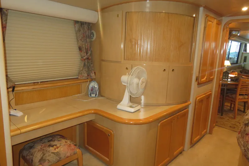 Just Us Yacht Photos Pics Interior of 2000 Bluewater Yachts 5800, featuring a cozy desk area with fan and seating.