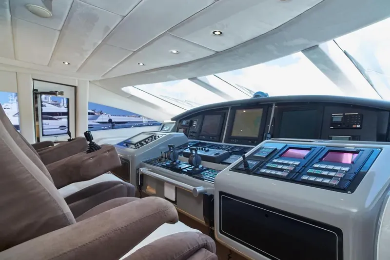  Yacht Photos Pics Luxurious 2003 Mangusta 108 yacht cockpit with advanced navigation systems and plush seating.