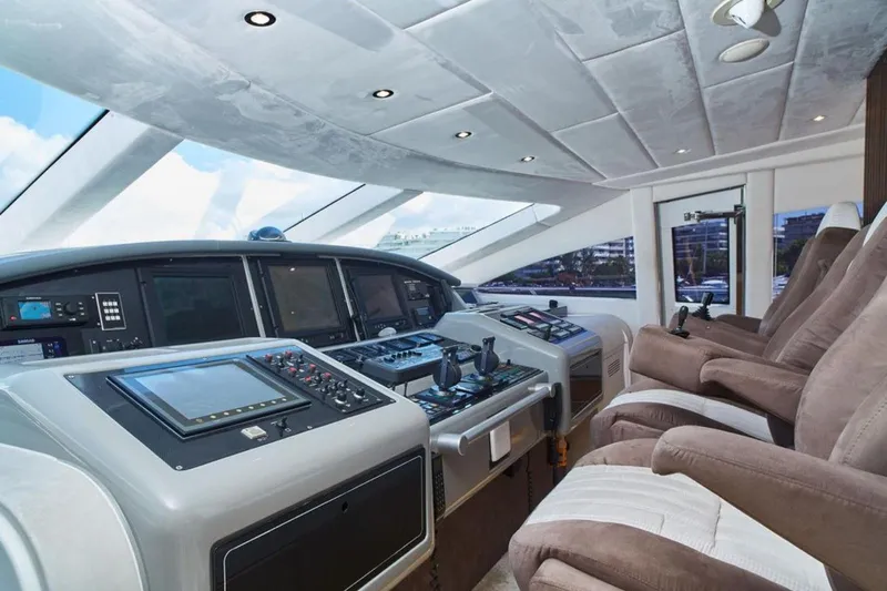  Yacht Photos Pics Luxurious 2003 Mangusta 108 yacht cockpit with advanced navigation systems and plush seating.