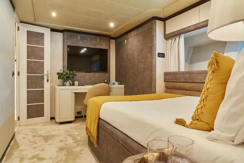  Yacht Photos Pics Luxurious bedroom interior on 2003 Mangusta 108 yacht, featuring elegant decor and modern amenities.