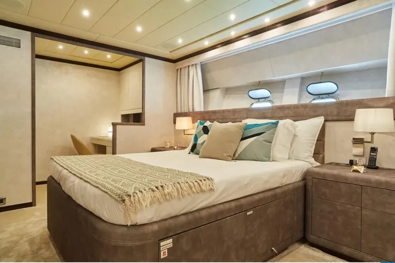  Yacht Photos Pics Luxurious bedroom interior on 2003 Mangusta 108 yacht, featuring elegant decor and modern amenities.