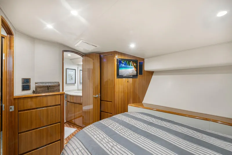  Yacht Photos Pics Luxurious 2009 Viking 50 Convertible yacht bedroom with wood accents and modern amenities.