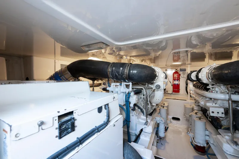  Yacht Photos Pics Engine room of 2009 Viking 50 Convertible yacht, featuring dual engines and fire extinguisher.