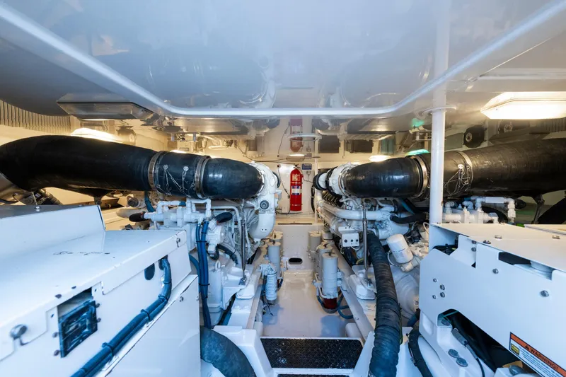  Yacht Photos Pics Engine room of 2009 Viking 50 Convertible yacht, featuring dual engines and fire extinguisher.