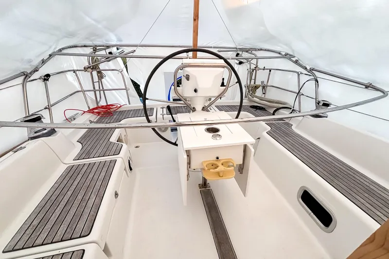 Marley Yacht Photos Pics Cockpit of 2015 Beneteau Oceanis 37 sailboat with steering wheel and seating.