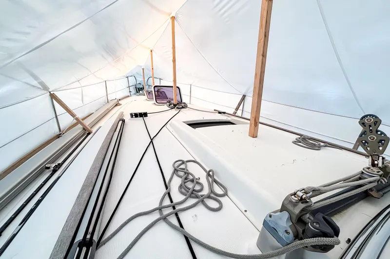 Marley Yacht Photos Pics Beneteau Oceanis 37 sailboat deck under protective cover, showcasing rigging and ropes, 2015 model.