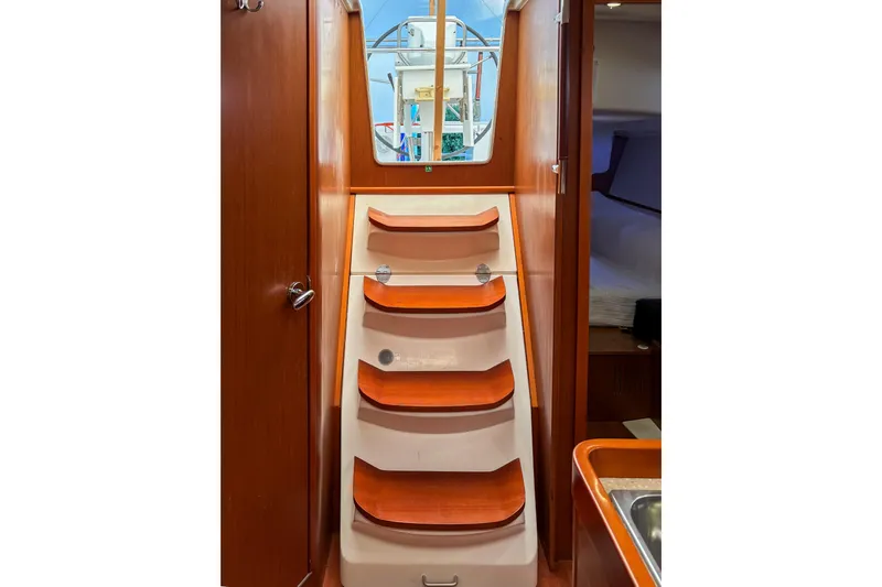 Marley Yacht Photos Pics Interior view of 2015 Beneteau Oceanis 37 sailboat with wooden steps and cabin access.
