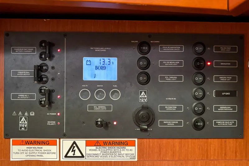 Marley Yacht Photos Pics Electrical control panel on a 2015 Beneteau Oceanis 37 sailboat, displaying voltage and warnings.